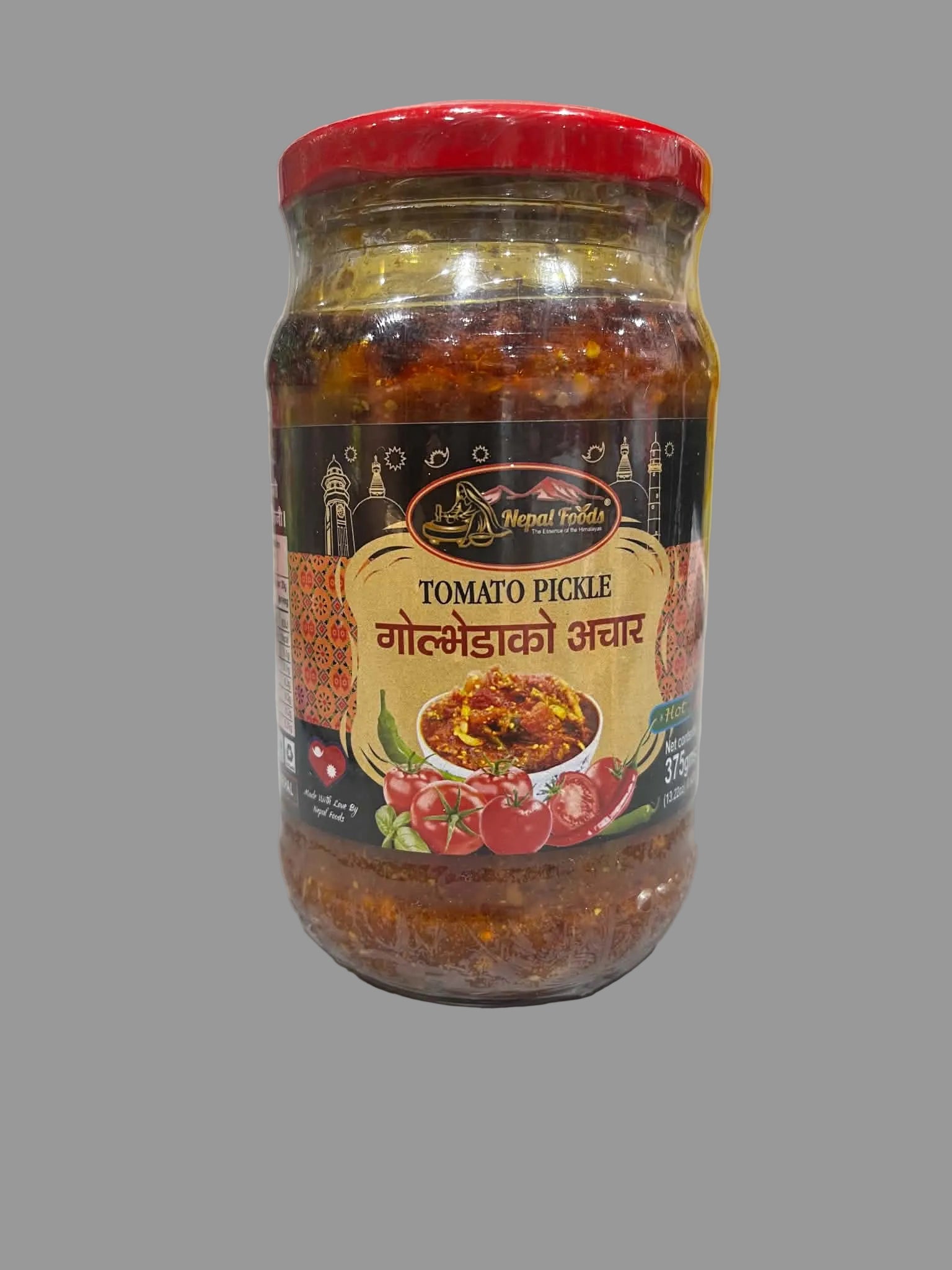 A glass jar of Neem Tikka Tomato Pickle with a red lid, placed on a light gray countertop with a blurred kitchen background.