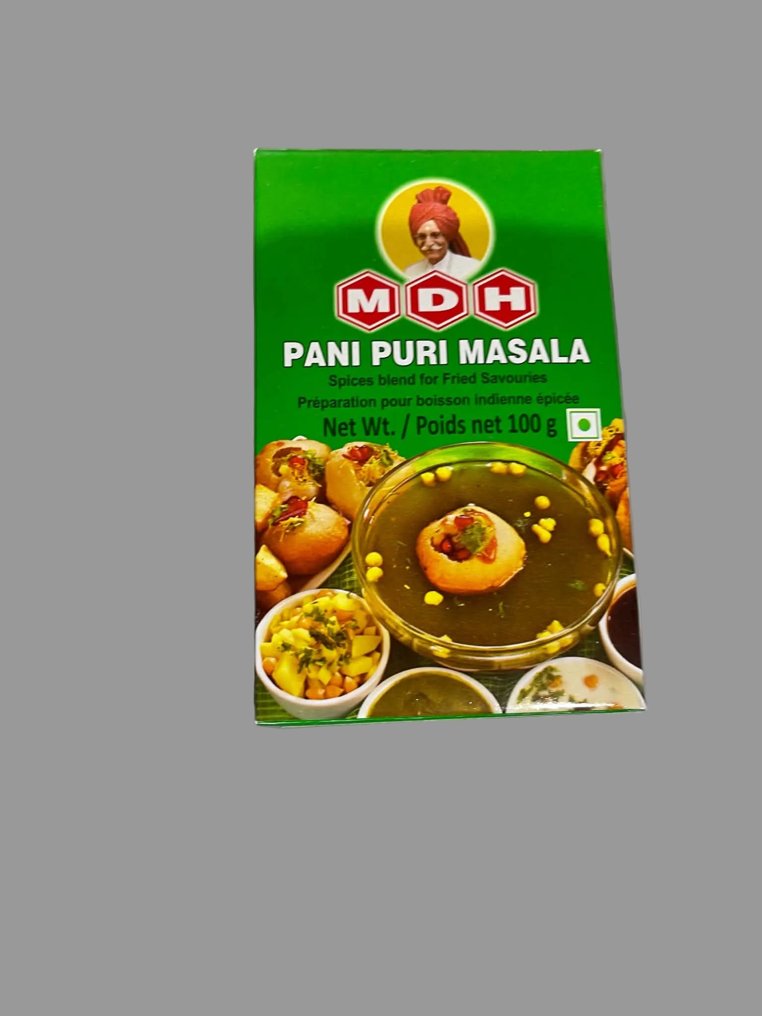 A package of MDH Pani Puri Masala spice blend, featuring a bright green box with the MDH logo, a portrait of the brand's founder, and an image of stuffed grape leaves in a bowl of spiced water.