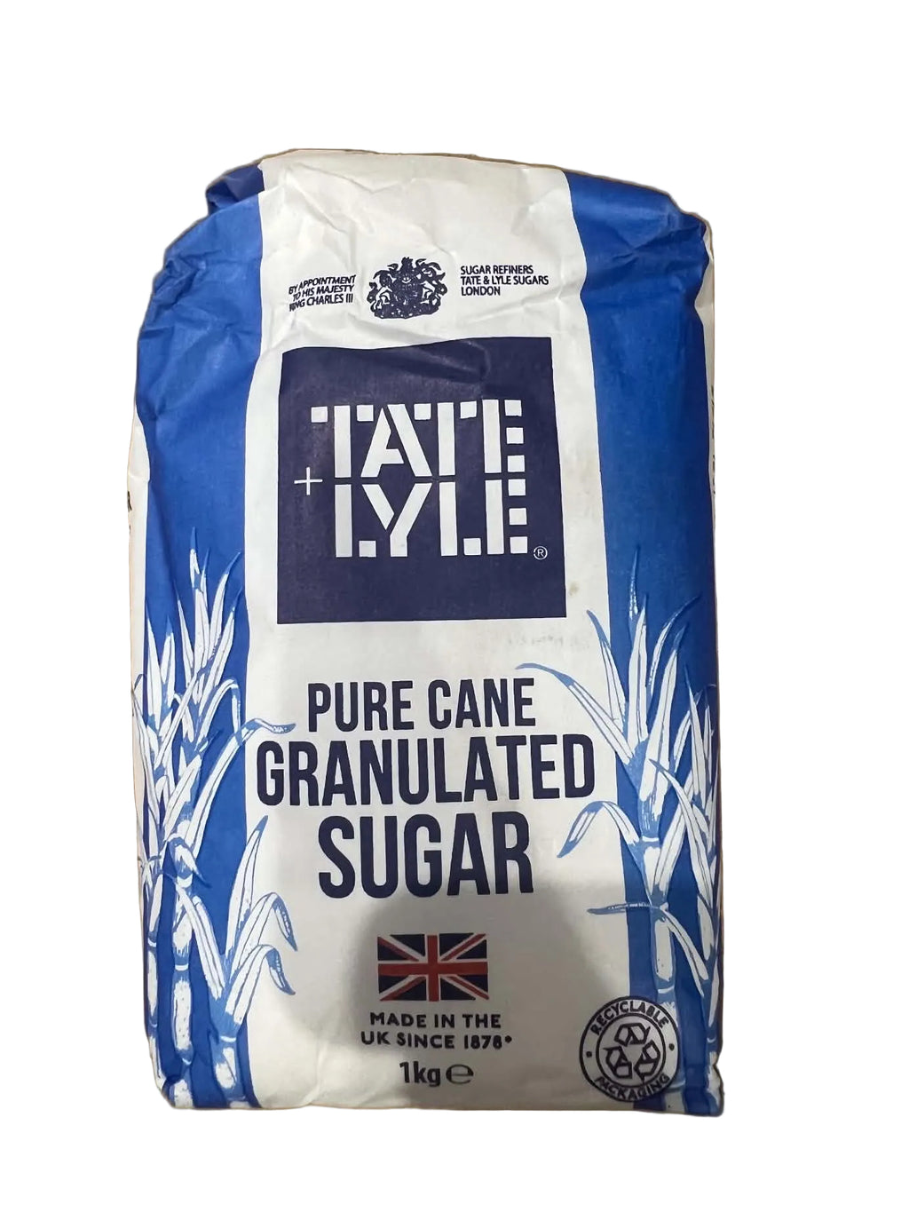 A 1kg bag of Fable Pure Cane Granulated Sugar, featuring its blue and white packaging, placed on a brown cardboard background.