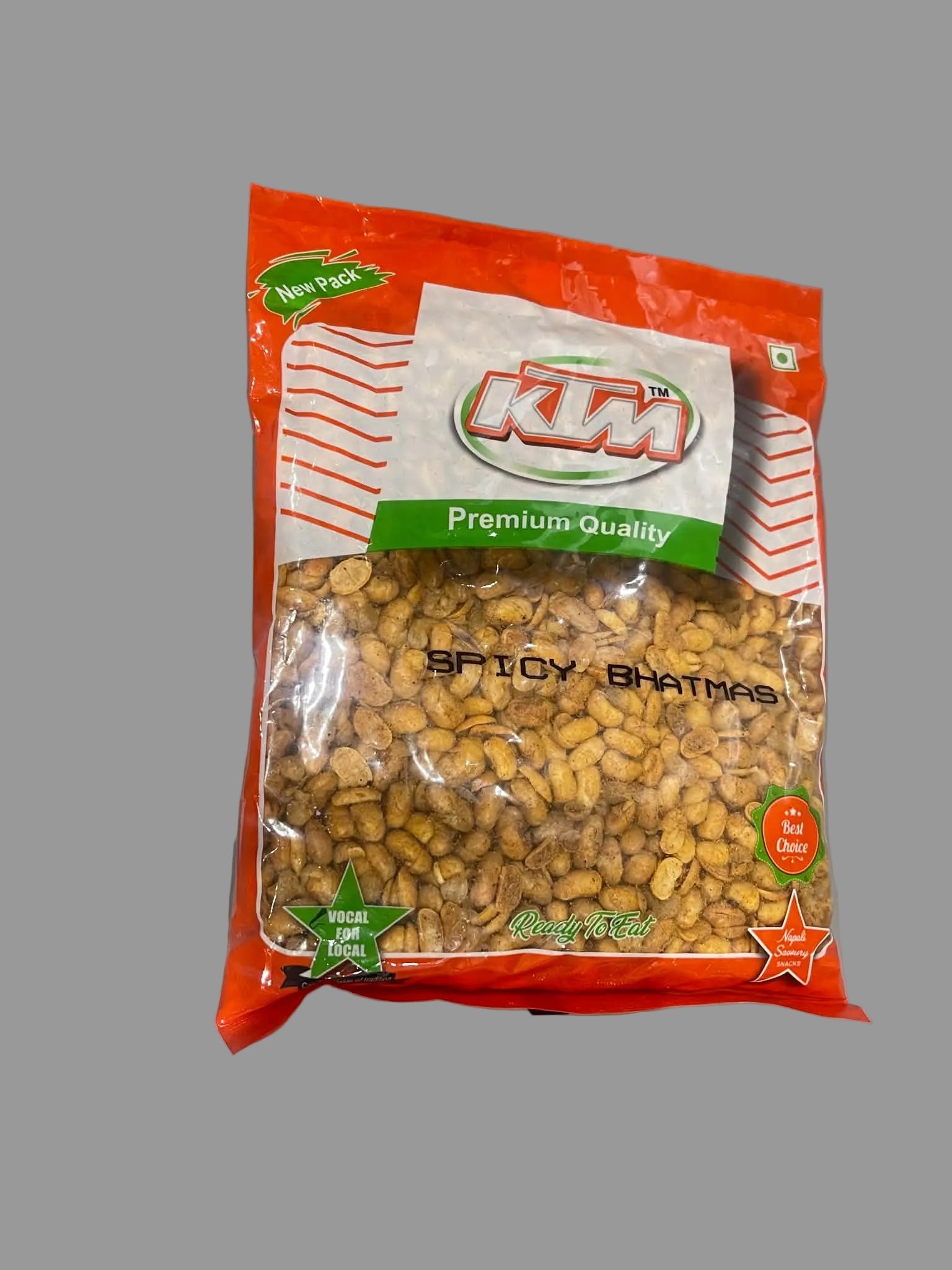 A bag of Kumaari Spicy Bhatmas, featuring a bright red and white packaging with a clear window showing the golden-brown fried lentil pieces inside, placed on a gray surface.