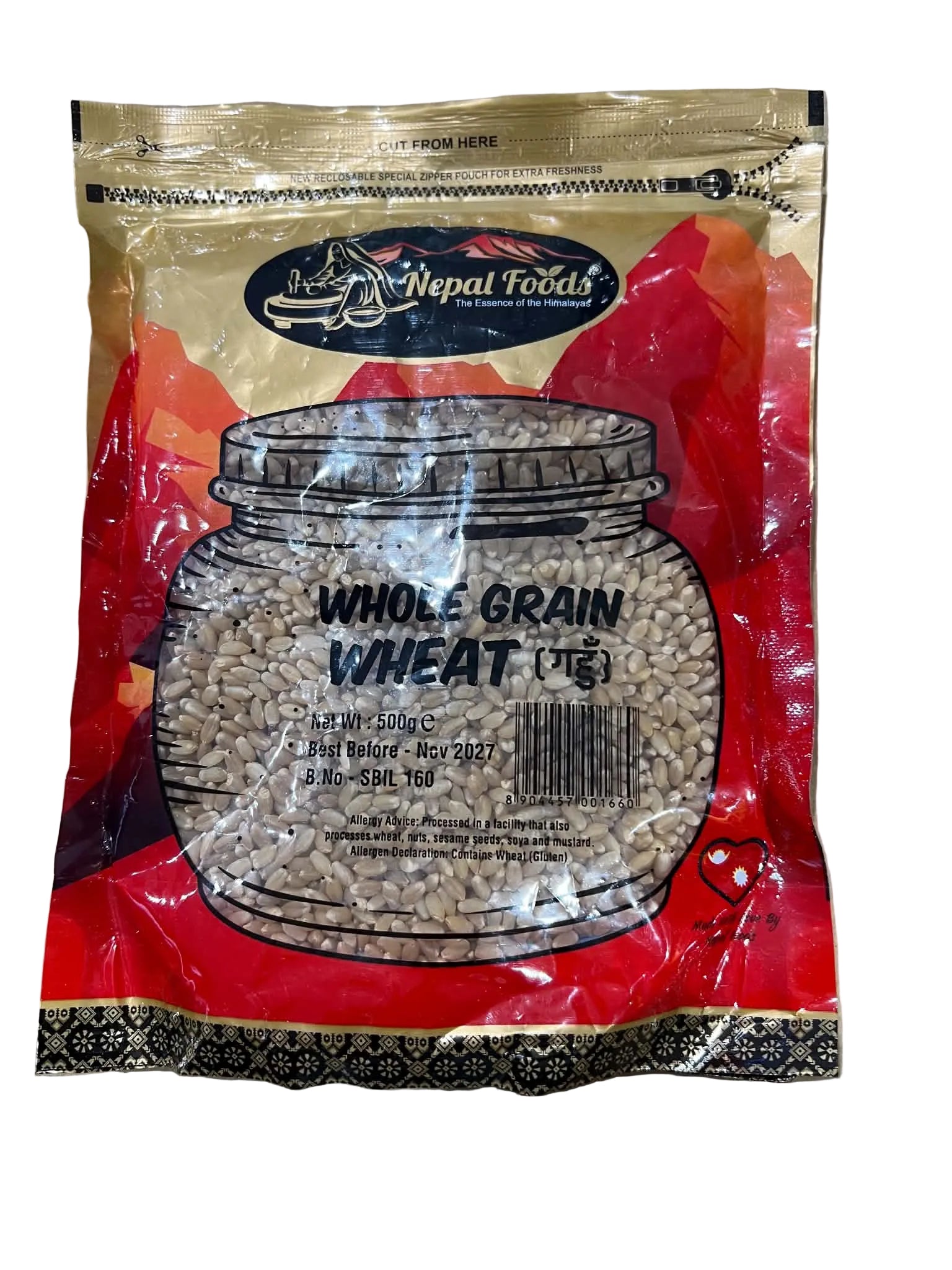 A bag of Nepal Foods Whole Grain Wheat (1 kg) on a neutral surface. The packaging features a prominent red and gold design with an illustration of a glass jar filled with the wheat grains.