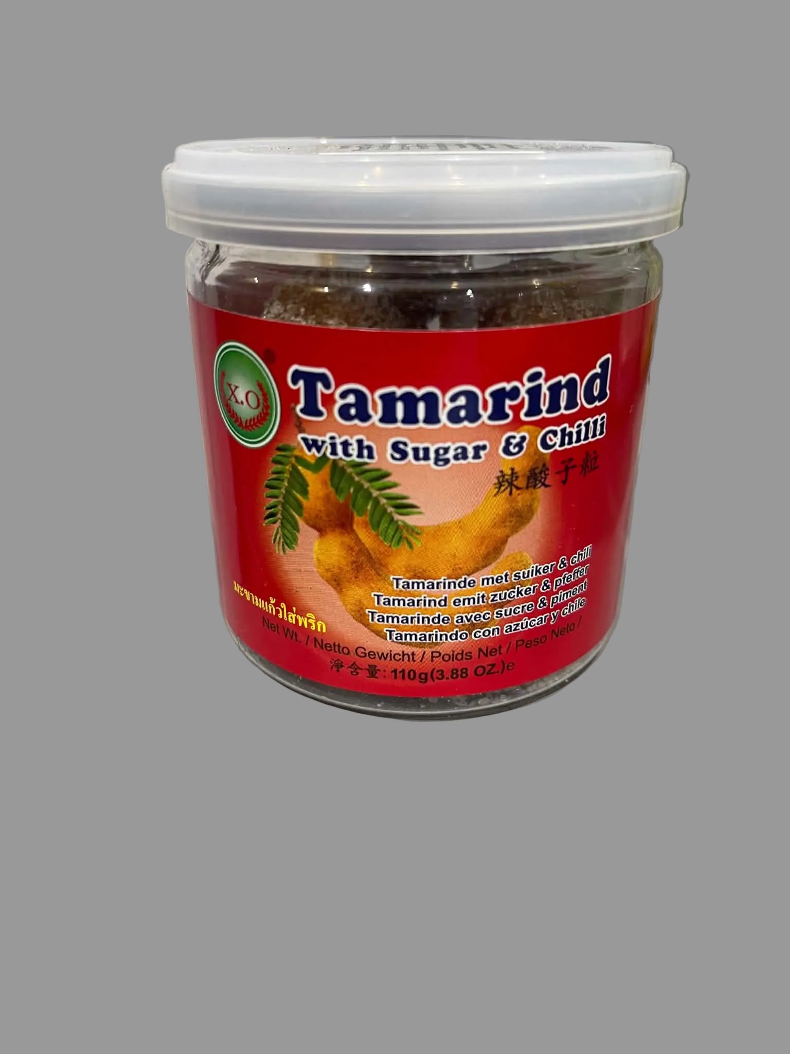 A jar of XO Tamarind with Sugar & Chili, featuring a bright red label and a white lid, sitting on a light gray countertop.