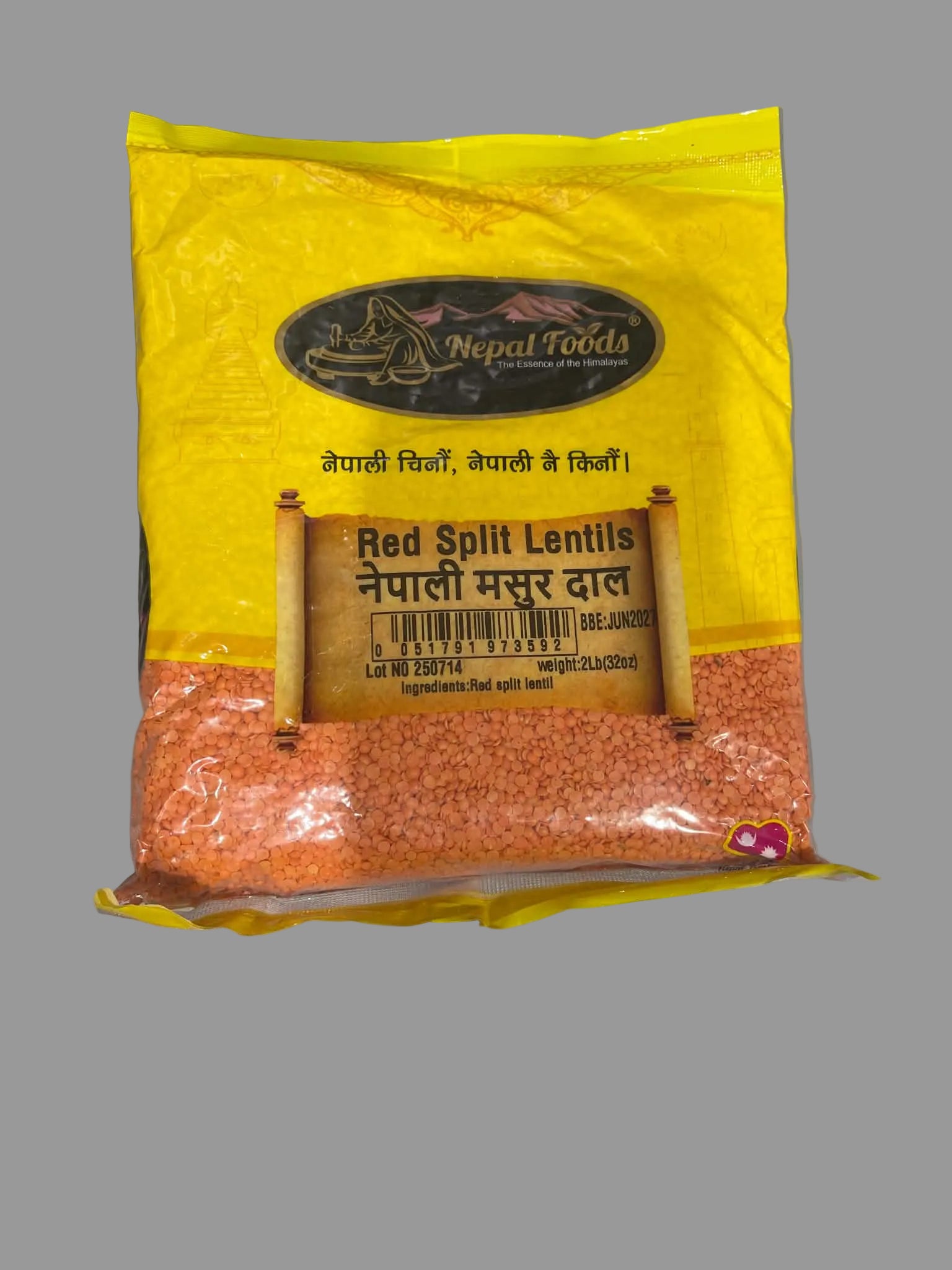 A bag of Nepal Foods Red Split Lentils, featuring a bright yellow upper half and a clear lower half showing the orange-red lentils inside, placed on a light gray surface.
