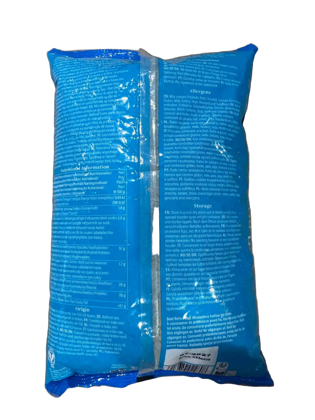 Two blue plastic pouches of a product with white printed text, placed on a brown cardboard surface.