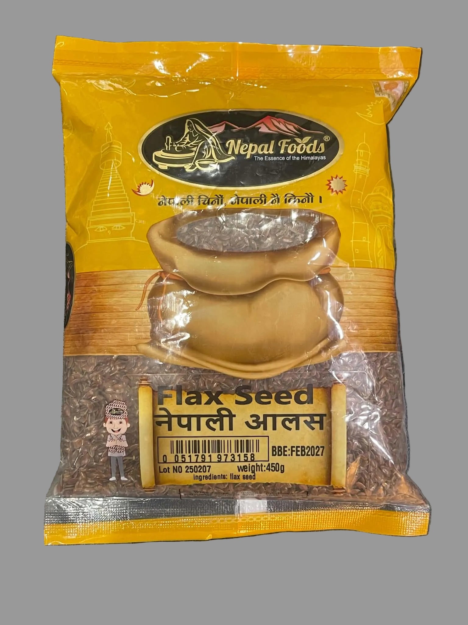 A 450g bag of Nepal Foods Nepal Aalss Flax Seed, featuring a bright yellow and brown packaging design with a picture of a sack of flax seeds, placed on a dark gray textured surface.