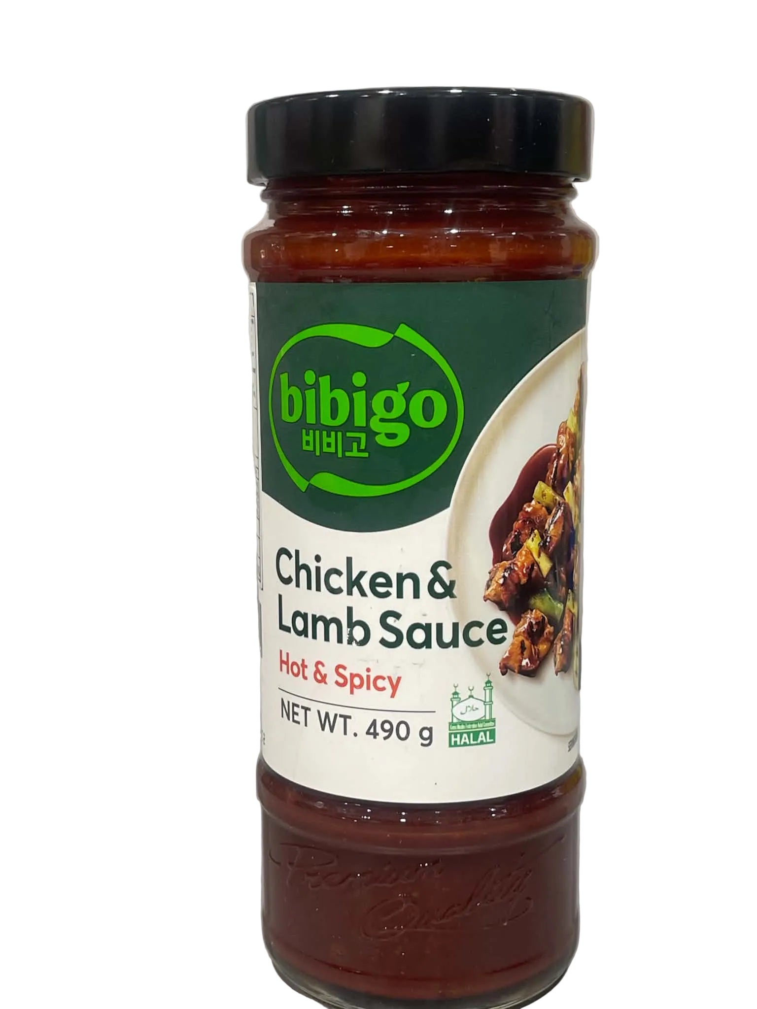 A jar of bibigo Chicken & Lamb Sauce, Hot & Spicy, with a black lid and a green and white label, set against a light gray marble background.