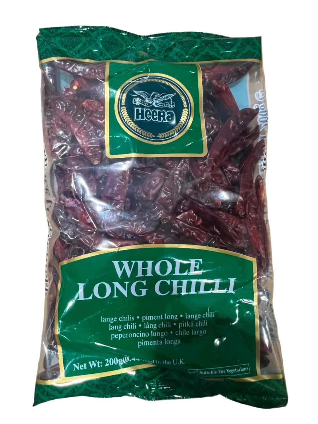 A bag of whole long chili peppers in a clear plastic package with green and gold labels, placed on a brown cardboard box.