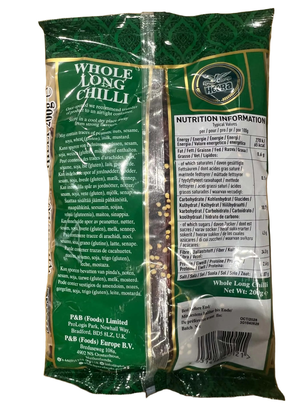 A package of Whole Hog Chilli dried red chilis, showing the back of the green and white bag with product details, nutrition facts, and a circular logo, placed on a brown cardboard surface.