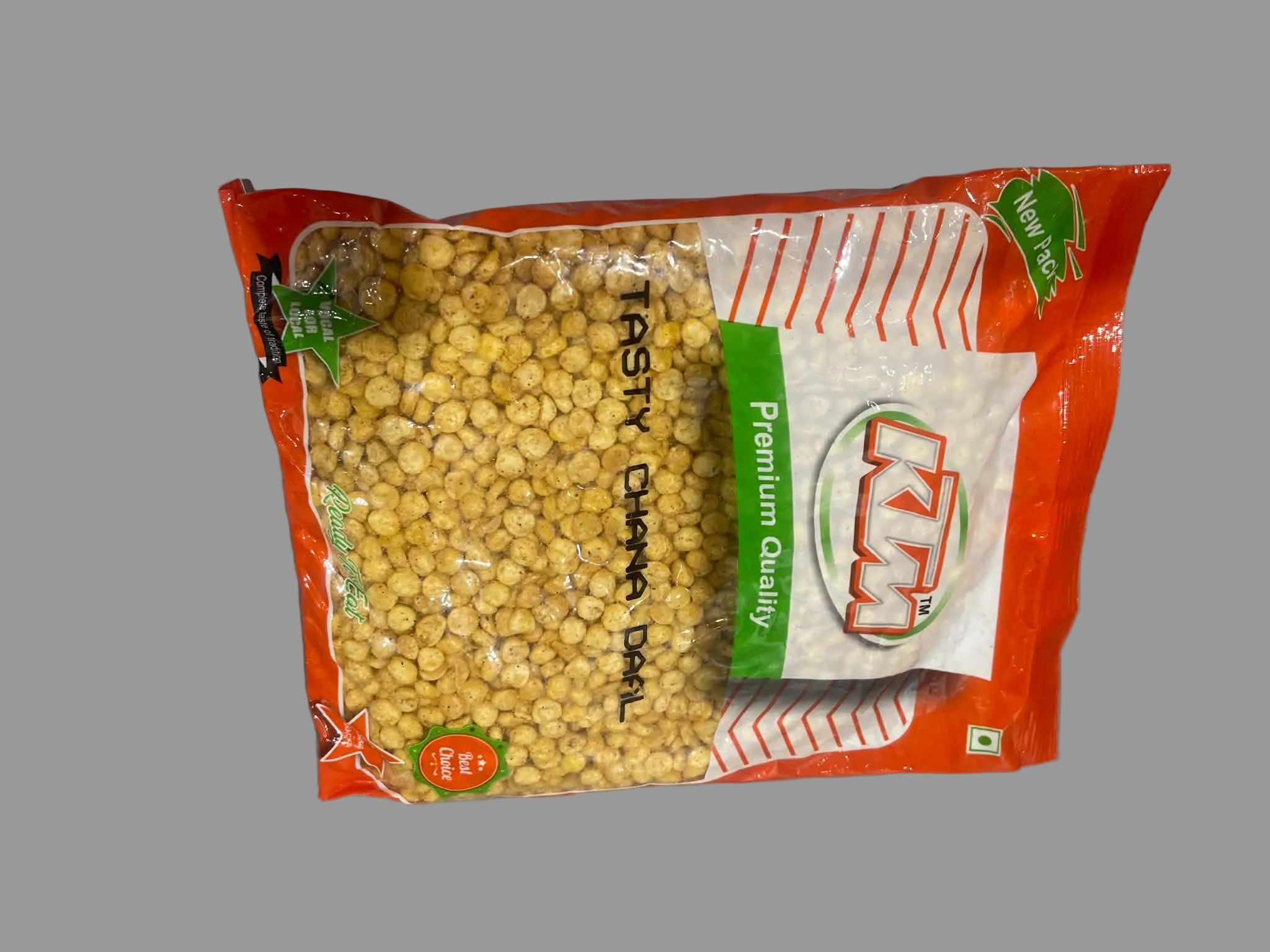 A bag of KZM Ready to Cook Chana Dal (split chickpeas) on a plain gray surface. The packaging is bright red and white with a clear window showing the yellow chickpeas inside, and a green vertical banner reading 'Premium Quality'.