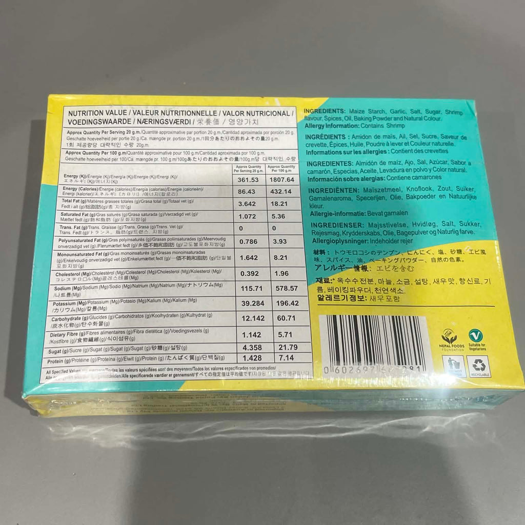 The back of a packaged food box, showing nutrition facts, ingredients, and a barcode, wrapped in clear plastic on a gray surface.