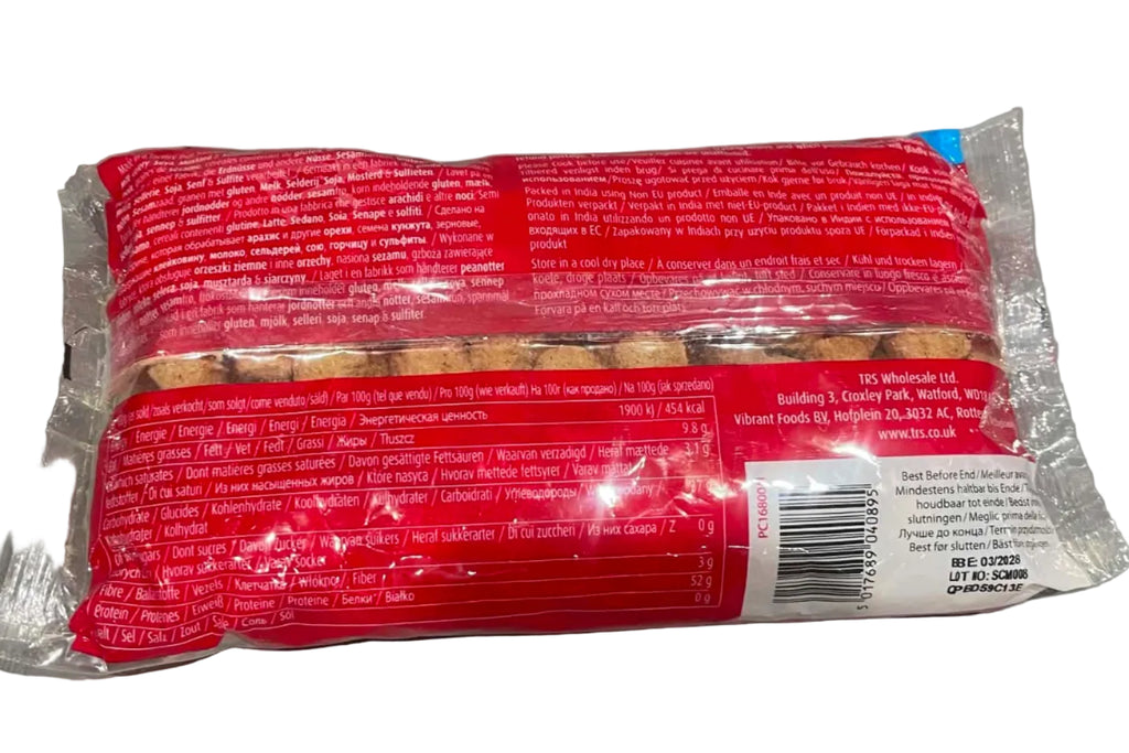A packaged food product, likely a sausage or meat roll, in clear plastic wrapping with a bright red label and a white barcode sticker, photographed on a gray tabletop.