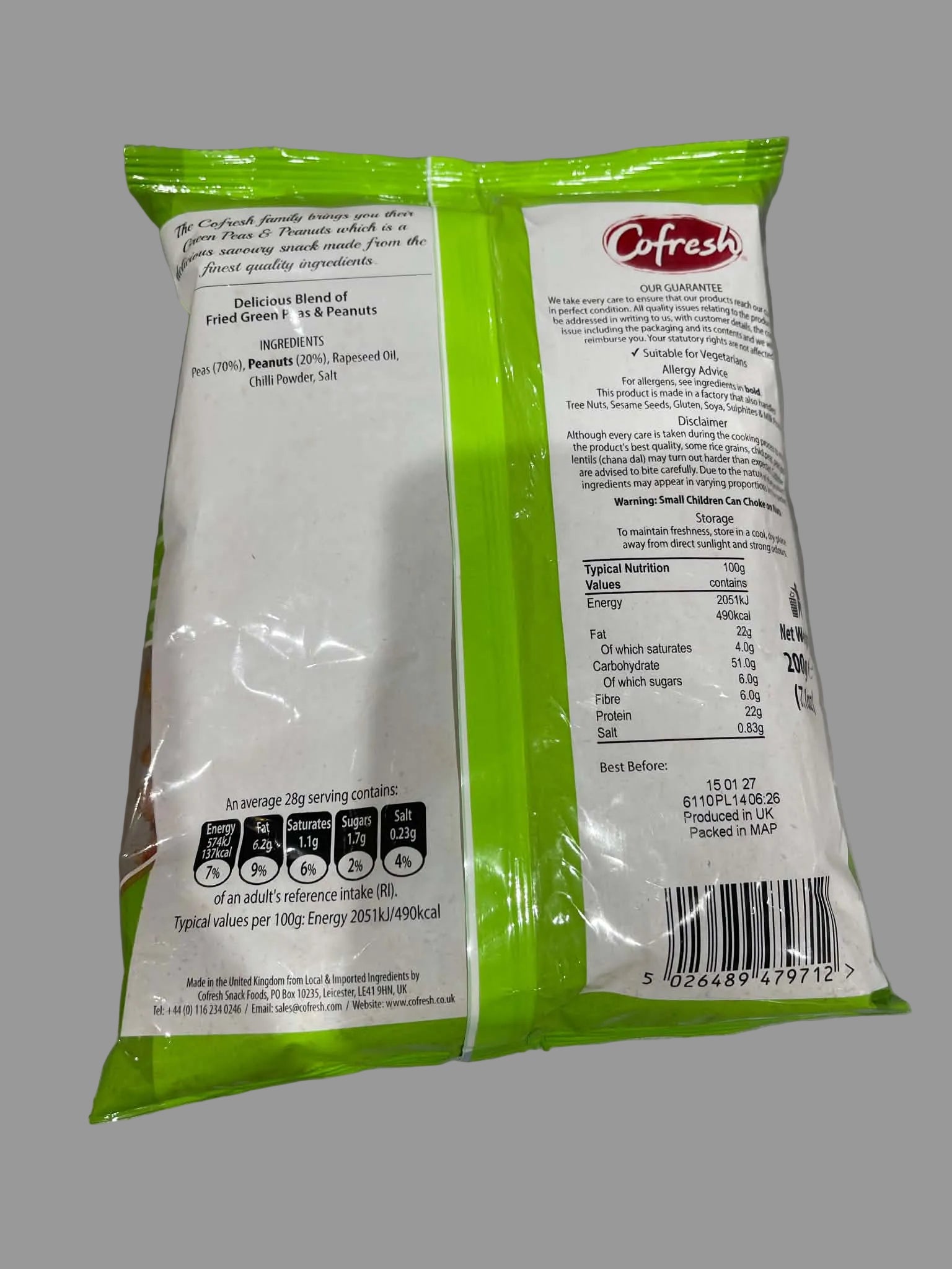 The back of a green and white plastic bag of Citruss Fresh food, showing printed ingredients, nutrition facts, and barcode information on a gray surface.