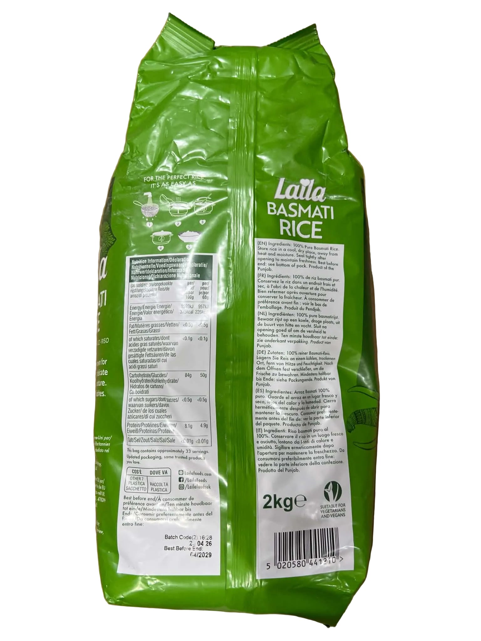 A 2kg bag of Lata Basmati Rice, showing the back of the green packaging with white labels, placed on a brown cardboard surface.
