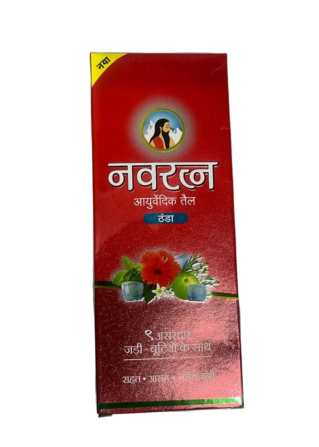 A red rectangular box of Navrakna Ayurvedic Teel, featuring Hindi text and illustrations of herbs and flowers, photographed on a gray surface.